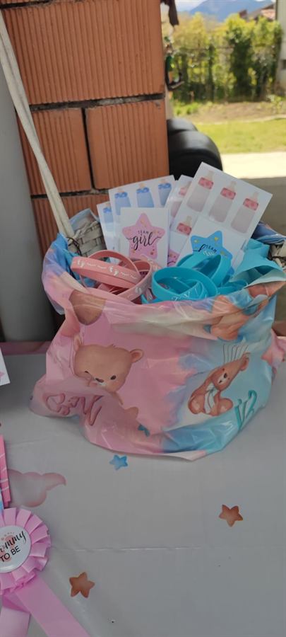 Cesto con sacchetti regalo rosa e azzurri coordinati alla festa